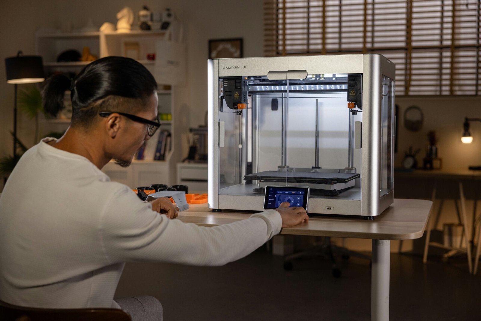 a man fixing a 3d printer